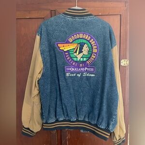 Vintage denim jacket. accent sleeves lg patch on back, pin & embroidered front